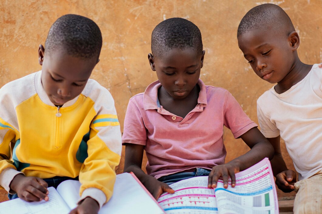 https://souriresdenfant.org/wp-content/uploads/2024/07/close-up-african-kids-reading-together_23-2148860425.jpg